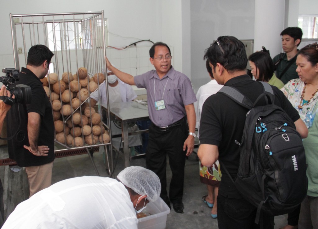 PhilMech Chief Science Research Specialist and Division Chief Dr. Ofero A. Capariño (center) shows the process of coco water extraction to the World Bank team who visited the coco water processing facility at DA-RFO V Compound on February 3, 2015.