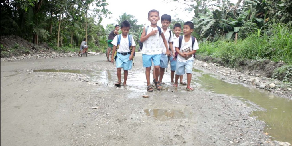 Pupils from the Dulangan I Elementary School have to walk through the muddy and uneven dirt road when going to and from school. The road is muddy during the rainy season and dusty during the dry season. (Photo by: Kathrino Resurreccion, DA-PRDP)