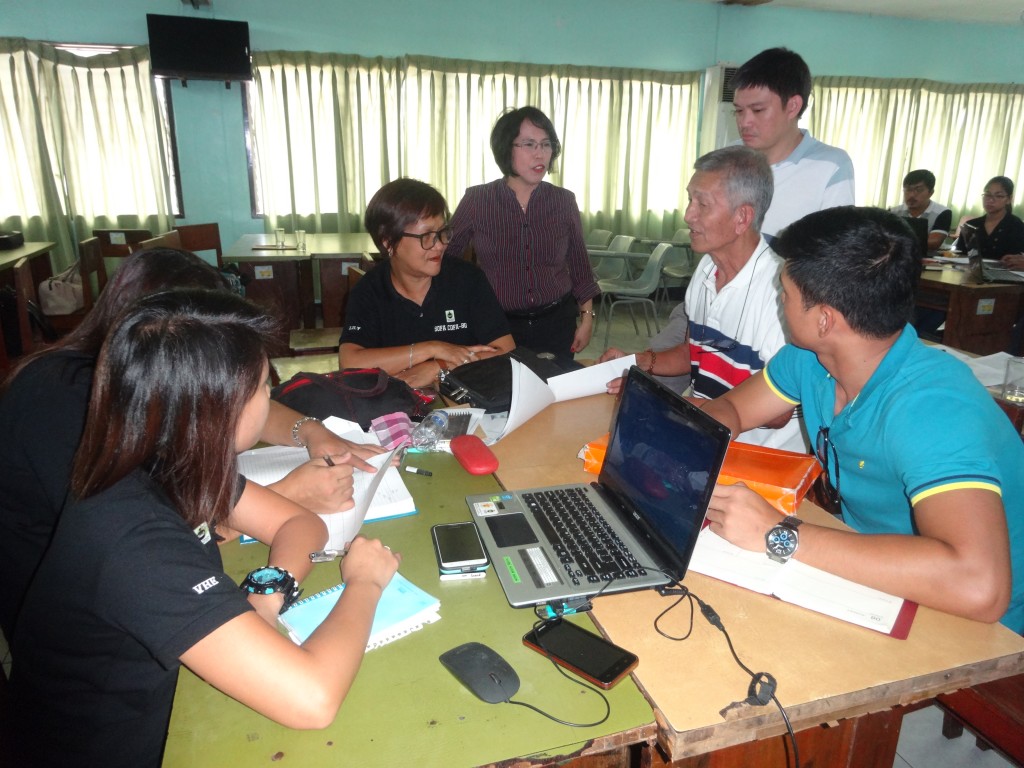 NPCO Enterprise Development and Marketing Specialist Charito A. Cadorna (center, in long sleeve top) assists the Samahang Organic Fair Trade Coconut Farmers Bicol Quezon (SOFACOFA-BQ) in formulating the cooperative’s Operations Manual. (Photo by Annielyn L. Baleza) 