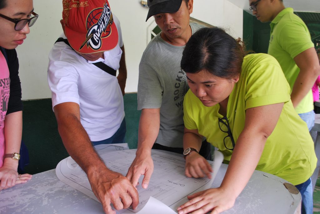 PRDP South Luzon PSO Rural Infrastructure Engineer Ma. Concepcion Ordiales studies the engineering design for the guyabano puree processing facility in Tayabas City.