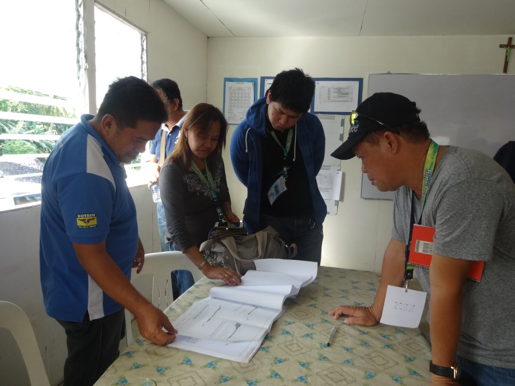 The participants of the Training on Infrastructure Quality Monitoring and Durability System (IQMDS) scrutinize the document control system for the Rehabilitation/Improvement of Pistola-Tablon Road with 3 Units Bridges during an actual fieldwork held on October 18, 2016 in Oas, Albay.  (Photo by Annielyn L. Baleza, DA-PRDP RPCO V InfoACE Unit)